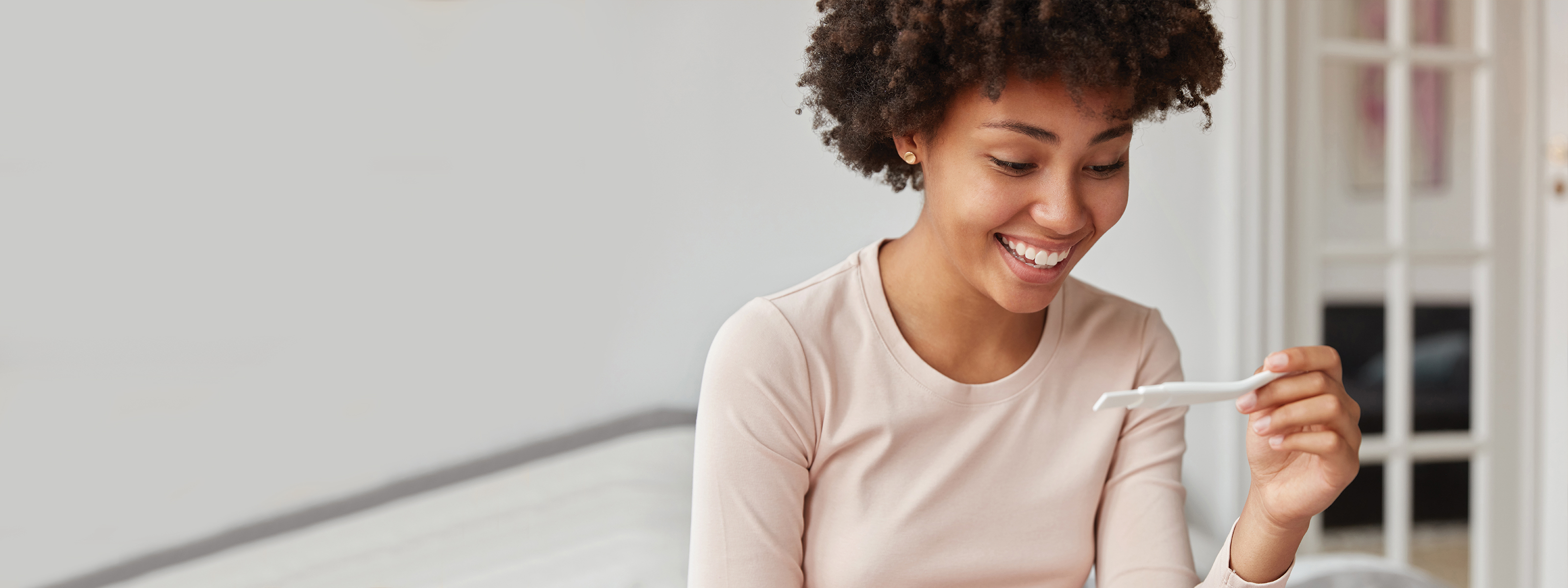 woman reading pregnancy test