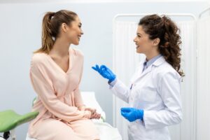 woman talking to female doctor in office.